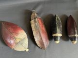 four different types of wooden fishing lures lined up on a table