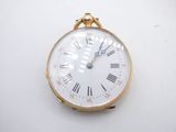 a gold pocket watch with roman numerals on the face