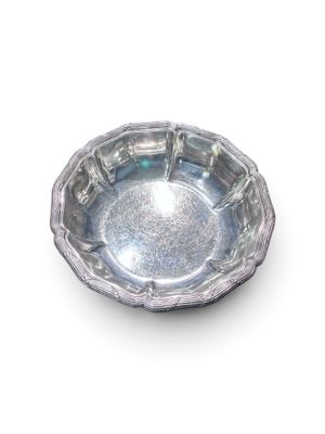 une assiette en argent posée sur une surface blanche