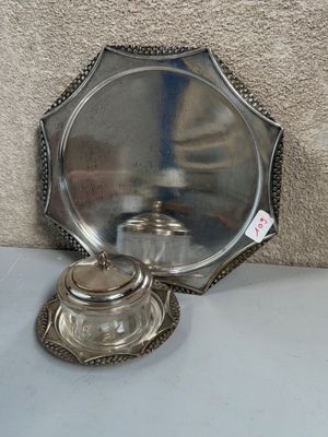 a silver plate with a silver lid on a table