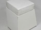an image of a white ottoman with a cushion on top