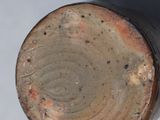 a close up of a brown vase with a white background
