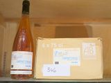 a bottle of wine sitting on a shelf next to a box