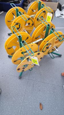 a lot of yellow reels on a cart on the ground
