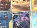 several pokemon cards are displayed on a table in a room