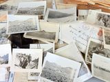 a lot of old postcards sitting on a table