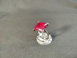 a red umbrella sitting on top of a silver ring