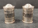 pair of silver salt and pepper shakers on a table