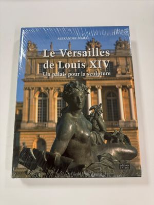 the book is sitting on a table in front of a building