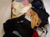 a suitcase full of clothes that is sitting on the floor