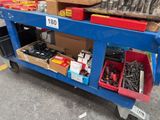 a blue cart with tools on it in a parking lot