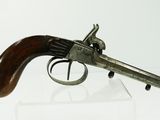 an old gun with a wooden handle on display on a white surface
