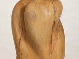 wooden sculpture of a woman ' s torso on a white pedestal