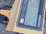 a box with a digital display on it sitting on the ground