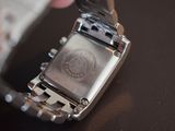 a close up of a person holding a wrist watch