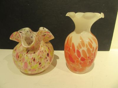two vases that are sitting on a table