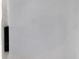 a close up of a piece of paper on a white surface