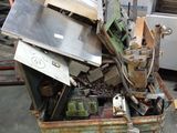 a pile of junk in a metal container next to a stove