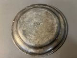 a silver plate with a hole in the middle of it
