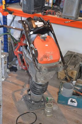 an image of a man working on a machine in a garage