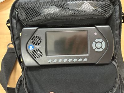 a black bag with a video game system inside of it