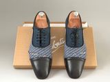a pair of black and blue shoes sitting on top of a box