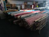a lot of different colored fabrics on a table in a room
