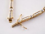 two pieces of jewelry that are laying on a table