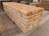 a pile of lumber stacked on top of each other in a warehouse