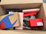 a cardboard box filled with assorted items on the floor