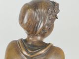 bronze statue of a woman with a scarf on her head