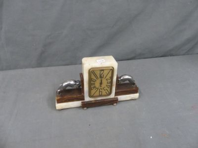 a small clock sitting on top of a wooden stand