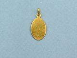 a gold plated pendant with a coin on a blue background