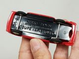 a person holding a red and black cellphone in their hand
