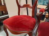 a red chair that is on display in a room