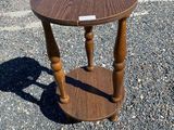 a small wooden table with a sticker on the top of it