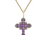 an amethorate and diamond cross pendant on a gold chain