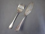 two forks and two spoons on a table