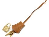 a brown leather key case with a lock and two keys on it