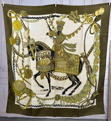 a green and gold scarf with a woman riding on a horse