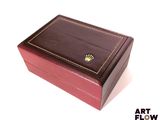 a brown box with a crown on it on a white surface