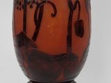 a brown vase with black designs on it on a white background