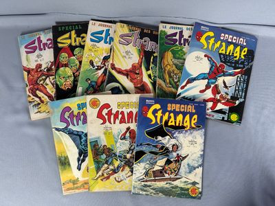 Plusieurs bandes dessinées sont alignées sur un lit recouvert d'un drap bleu
