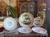 a lot of plates that are sitting on a table