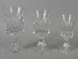 three clear wine glasses sitting next to each other on a table