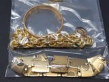 a gold bracelet and a gold bracelet on a plastic bag