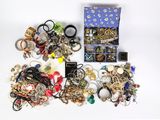 a box of assorted jewelry on a white surface