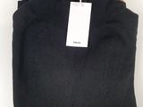 a black sweater with a tag on it