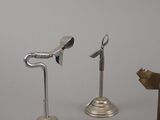 three metal objects that are sitting on a table