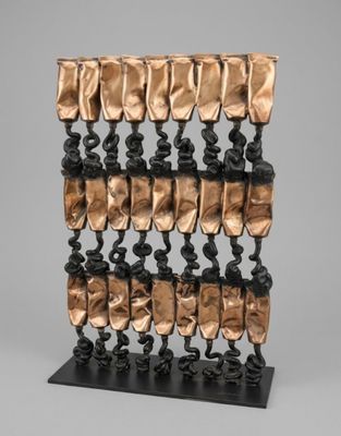 a close up of a sculpture on a stand with many pieces of metal